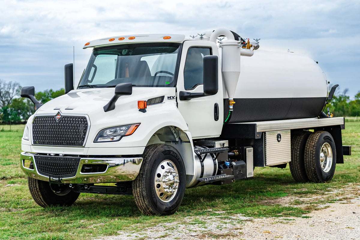2026 International MV-607 Vacuum Truck for sale equipped with a 2500 Gallon Carbon Steel Tank parked in a grassy field | Arkson Truck Co
