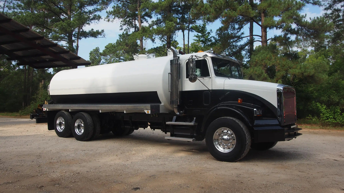 A white and black custom vacuum truck built by Arkson Truck Co, a vocational truck builder based in Northwest Arkansas serving customers throughout the United States.