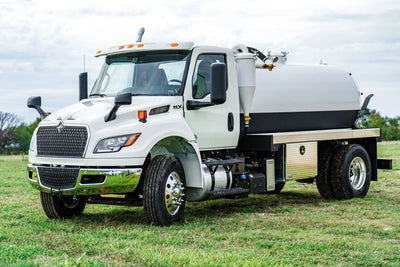 2026 International MV-607 Vacuum Truck for sale equipped with a 1900 Gallon Carbon Steel Tank parked in a grassy field | Arkson Truck Co